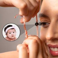 Thumbnail for Close-up of a woman wearing the Pink Photo Bracelet, featuring a personalized photo of a baby, by Brother & Sisters.
