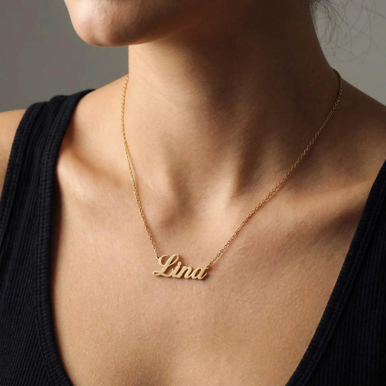 Minimalist Name Necklace in gold worn at the collarbone, the name Lina engraved in cursive script | SKU: minimalistnn-gold