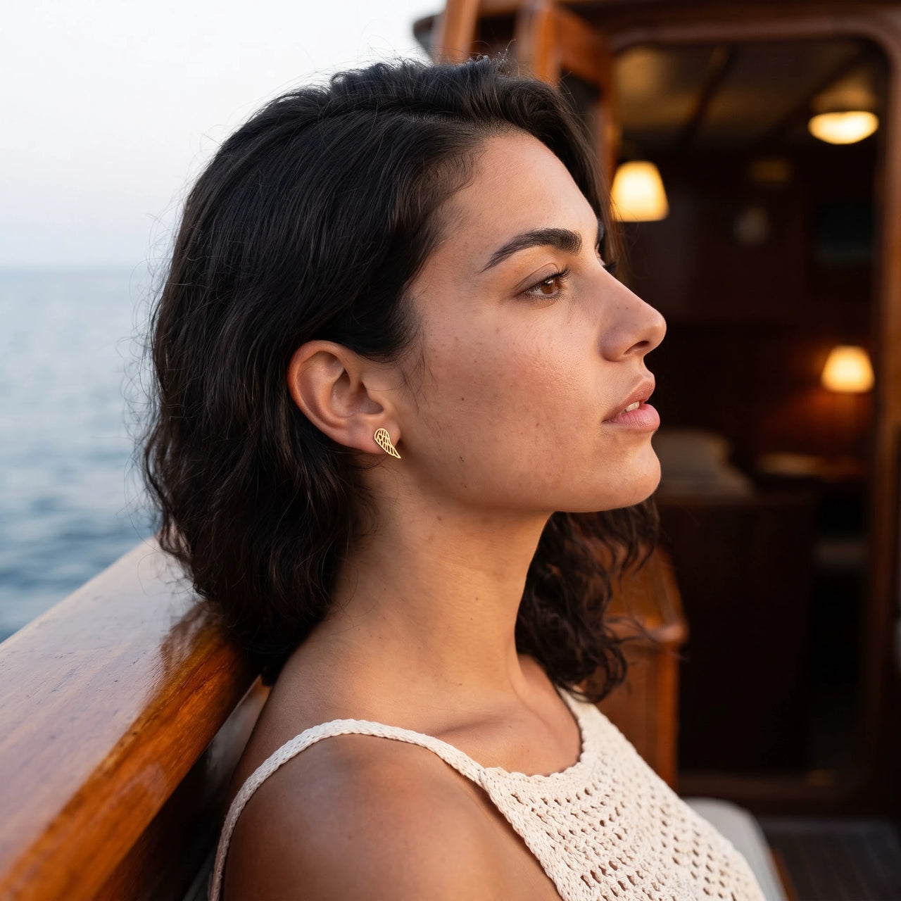 Profile view of a woman wearing the gold stud earrings | SKU: 42008-gold