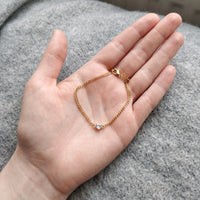 Thumbnail for Heart Bond Matching Bracelet Set in Gold — her bracelet resting in an open palm