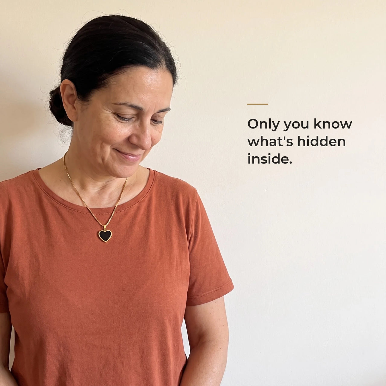 Woman wearing the gold heart pendant, black on the outside, only she knows the photo inside | SKU: TPH-CHTN-GOLD-SMALL