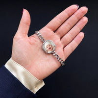 Thumbnail for Thumb warming the silver octagon bracelet plate: the hidden photo appears under the thumb while the rest stays black | SKU: TPH-OCTB-SILVER-18