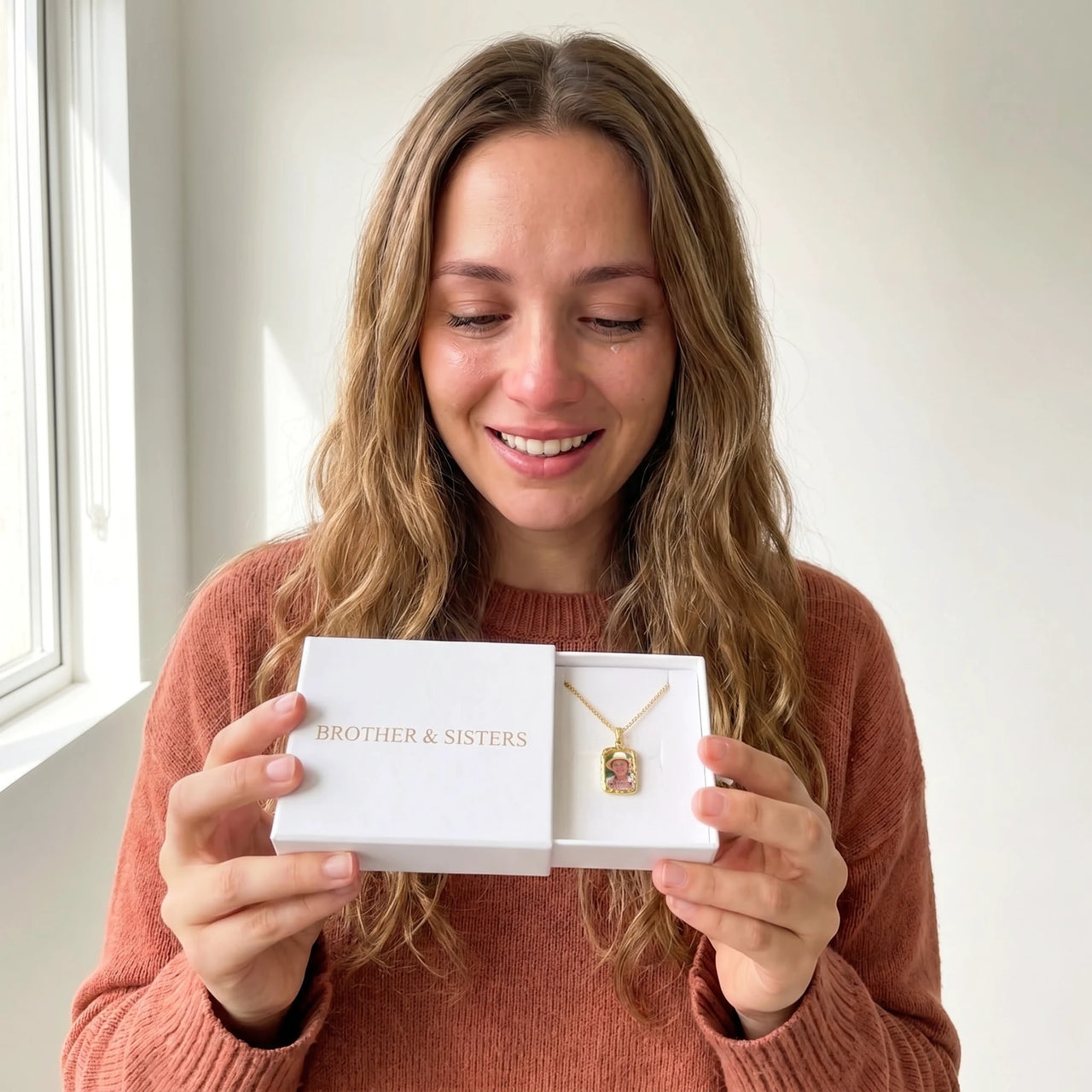 The gold oval photo necklace with her grandmother's photo in the Brother & Sisters gift box | SKU: TPH-OVLN-GOLD